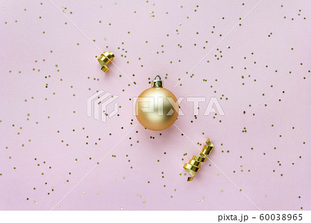 Christmas sparkles composition. Christmas ball and golden stars on pastel pink background. 60038965