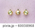 Golden christmas balls and stars on pastel pink background. Christmas sparkles composition. 60038968