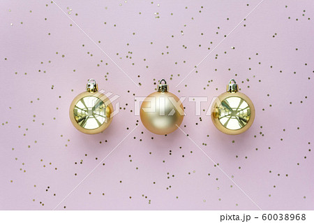 Golden christmas balls and stars on pastel pink background. Christmas sparkles composition. 60038968