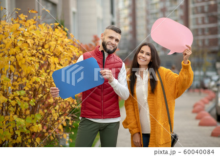 Joyful happy couple participating in social campaign Joyful happy couple participating in social campaign 60040084