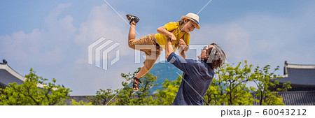 Dad and son tourists in Seoul, South Korea. Travel to Korea concept. Traveling with children concept Dad and son tourists in Seoul, South Korea. Travel to Korea concept. Traveling with children concept 60043212