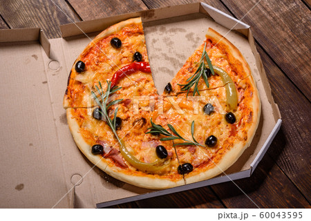 Tasty fresh hot pizza against a dark background 60043595