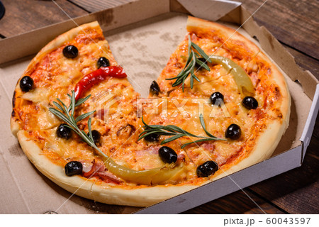 Tasty fresh hot pizza against a dark background 60043597
