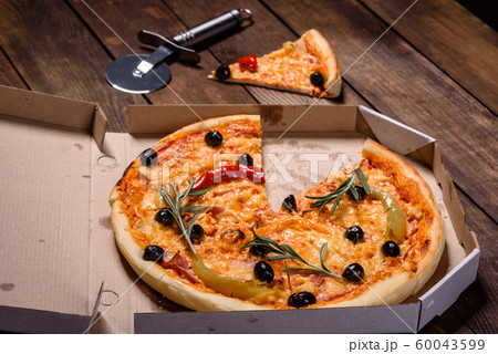 Tasty fresh hot pizza against a dark background 60043599