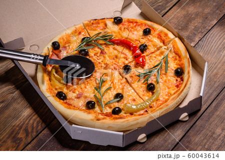 Tasty fresh hot pizza against a dark background 60043614