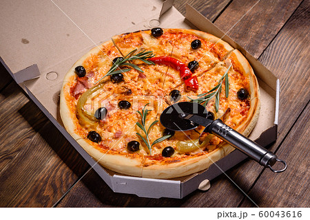 Tasty fresh hot pizza against a dark background 60043616
