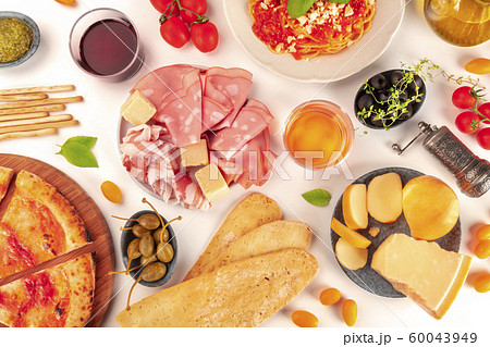 Italian food. Pizza, pasta, cheese, ham, wine, olives, pesto, tomatoes, shot from the top on a white background 60043949