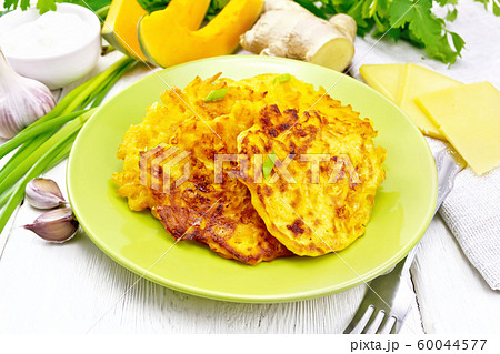 Pancakes of pumpkin with cheese in green plate_5 60044577