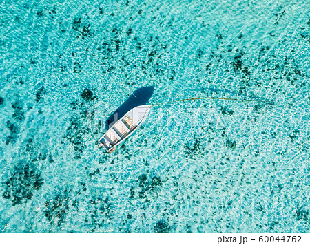 White boat in blue ocean in paradise island. Aerial view. White boat in blue ocean in paradise island. Aerial view. 60044762