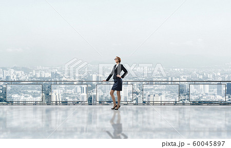 Sunrise above skyscrapers and businesswoman facing new day Sunrise above skyscrapers and businesswoman facing new day 60045897