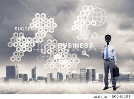 Camera headed man standing on wooden floor against modern cityscape 60046201