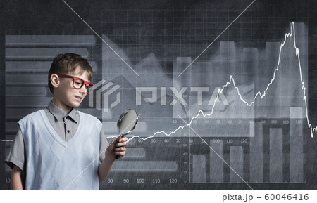 Curious school boy with magnifier 60046416