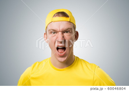 Frenzied teenager screaming with anger. 60046804