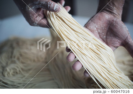 Making Handmade Noodles on wood background Making Handmade Noodles on wood background 60047016