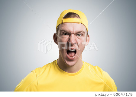 Frenzied teenager screaming with anger. Frenzied teenager screaming with anger. 60047179