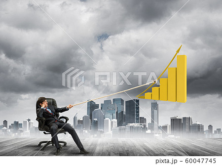 Man pulling with effort big pulling rope graph, as a symbol of financial growth 60047745