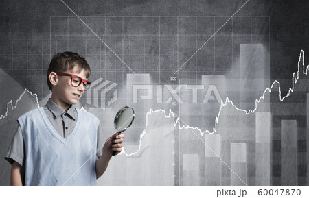 Curious school boy with magnifier 60047870