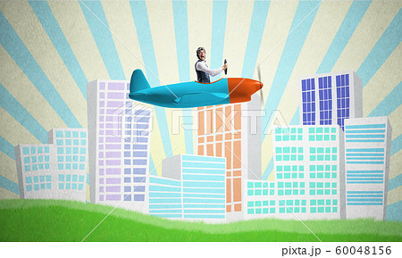 Man in aviator helmet sitting in propeller plane Man in aviator helmet sitting in propeller plane 60048156