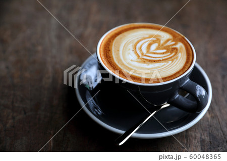 cappuccino or Latte art coffee made from milk on the wood table in coffee shop 60048365
