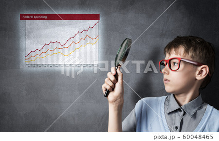 Curious school boy with magnifier Curious school boy with magnifier 60048465