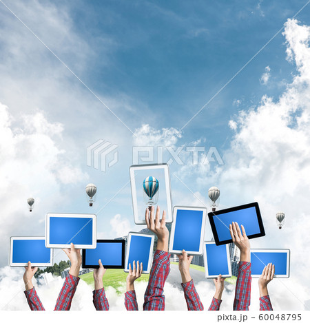 Close of woman hands in line showing tablet pc with blank blue screen 60048795