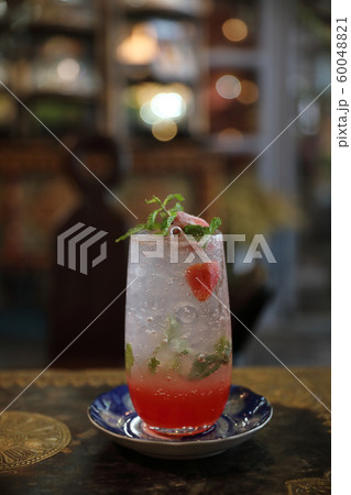 Strawberry mojito cocktail drink on wood background Strawberry mojito cocktail drink on wood background 60048821