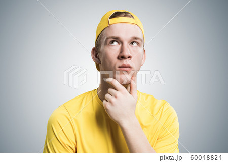 Redhead student looks pensively upwards 60048824