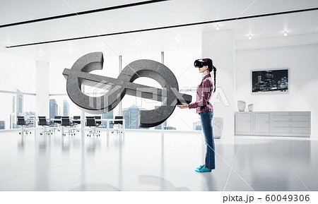 Girl in virtual reality mask experiencing virtual technology world. Mixed media 60049306