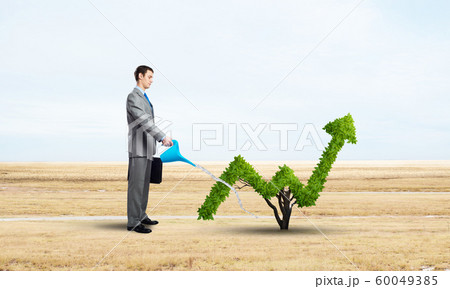 Green plant in shape of of grow up trend 60049385