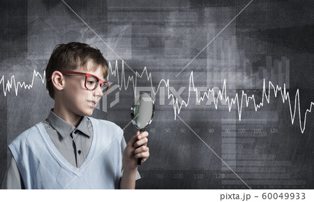 Curious school boy with magnifier 60049933