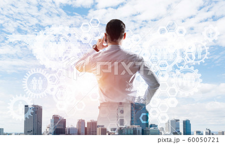 Concept of business success and control with confident boss against cityscape background Concept of business success and control with confident boss against cityscape background 60050721