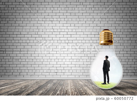 Businessman trapped in bulb Businessman trapped in bulb 60050772