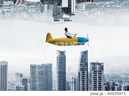 Aircraft pilot in leather helmet sitting in cabin 60050873