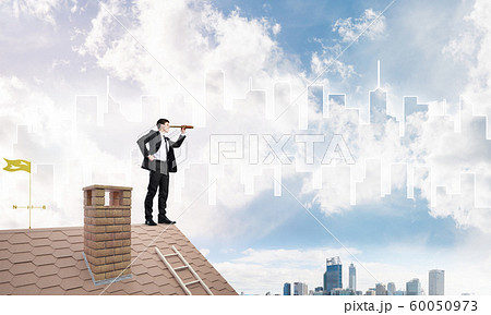 Engineer man standing on roof and looking in spyglass. Mixed media Engineer man standing on roof and looking in spyglass. Mixed media 60050973