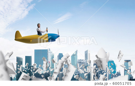 Satisfied emotional pilot sitting in airplane Satisfied emotional pilot sitting in airplane 60051705
