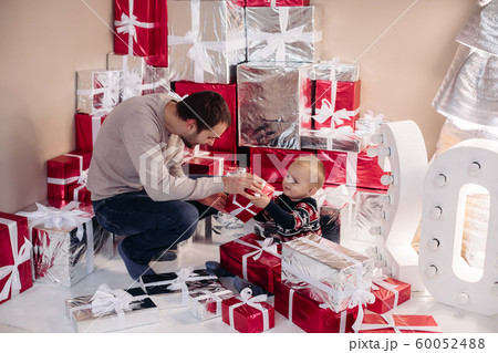 Loving dad giving present to his son. 60052488