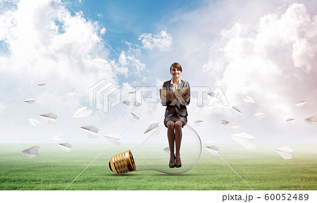 Young woman holding open book 60052489