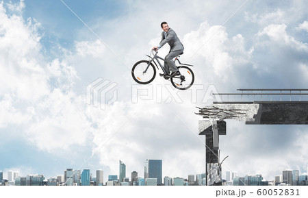 Businessman commuting to work by bike Businessman commuting to work by bike 60052831