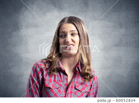 Displeased young woman looks squeamishly 60052834