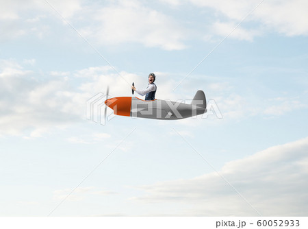 Happy pilot driving small propeller plane 60052933