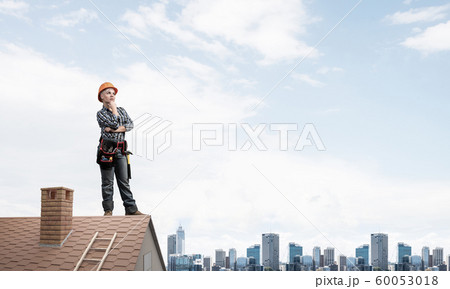 Pensive female construction worker in hardhat Pensive female construction worker in hardhat 60053018