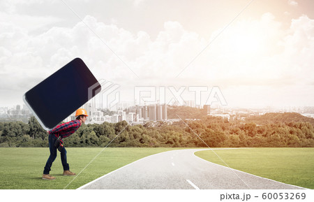 Builder man carry huge smartphone Builder man carry huge smartphone 60053269