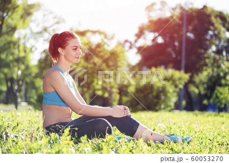 Beautiful smiling girl in sportswear relax in park 60053270