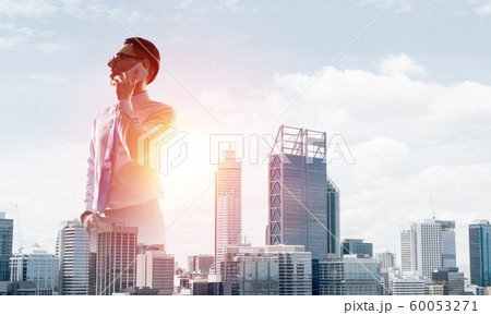 Concept of business success and control with confident boss against cityscape background 60053271