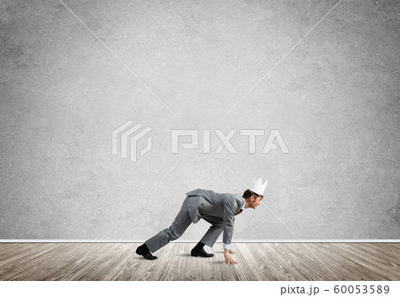 King businessman in elegant suit running in empty room 60053589