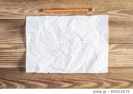 Sheet of paper lying on wooden table 60053670