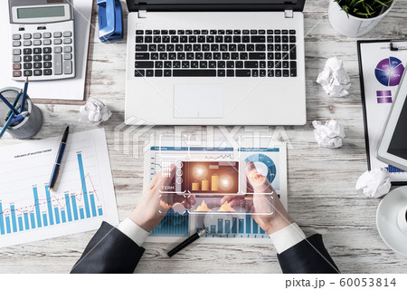 Businessman using smartphone at office desk 60053814