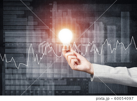 Businesswoman holding in hand glowing light bulb 60054097
