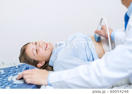 Portrait of happy woman at ultrasound examination Portrait of happy woman at ultrasound examination 60054246