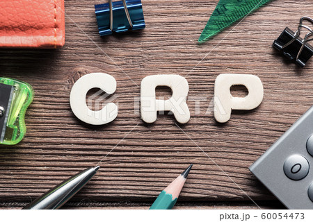 CRP word on wooden table and office stationary around 60054473